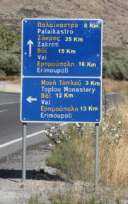 Road sign with Vai shown straight and to the left